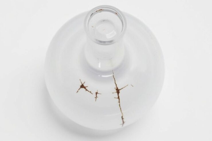 Uszkodzony smoczek w butelce z widocznymi pęknięciami wymagający natychmiastowej wymiany